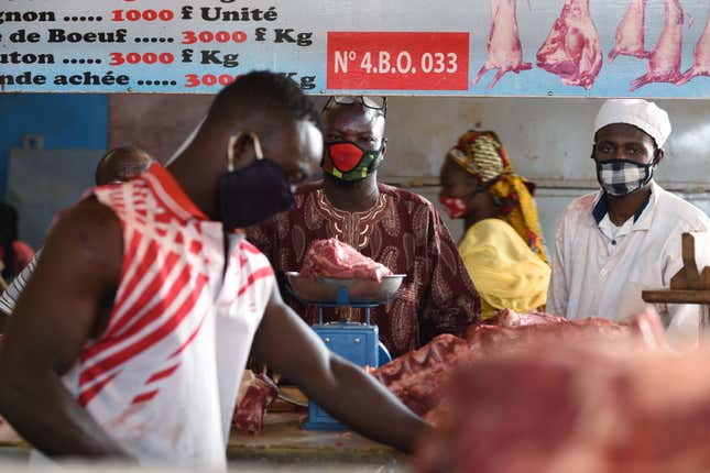 People wear face mask at a butcher Ouagadougou, Burkina Faso, April 20, 2020.