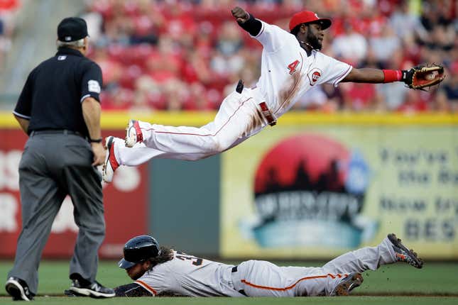FILE - San Francisco Giants&#39; Brandon Crawford, bottom, steals second base against Cincinnati Reds second baseman Brandon Phillips (4) in the second inning of a baseball game, May 15, 2015, in Cincinnati. Former Major League Baseball star Phillips and current women&#39;s pro wrestler Jade Cargill took on professional sports franchise ownership together less than a year ago. The pair led the Texas Smoke to the championship in their first season with Women’s Professional Fastpitch softball on Aug. 13, 2023. (AP Photo/John Minchillo, File)