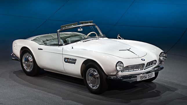 A white 1958 BMW 507 is parked with its top down