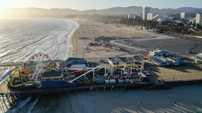 An aerial view of the shuttered Santa Monica Pier on Santa Monica Beach before sunset, on the day Los Angeles County reopened its beaches which had been closed due the coronavirus pandemic, on May 13, 2020 in Santa Monica, California.