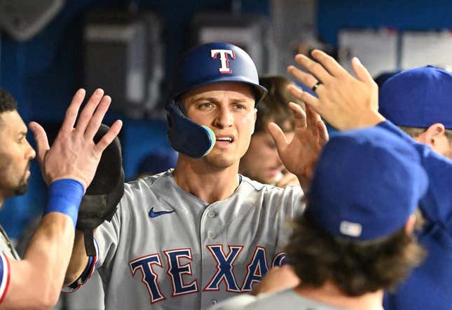 Sep 12, 2023; Toronto, Ontario, CAN;  Texas Rangers shortstop Corey Seager (5) celebrate with team mates in the dugout after scoring against the Toronto Blue Jays in the sixth inning at Rogers Centre.
