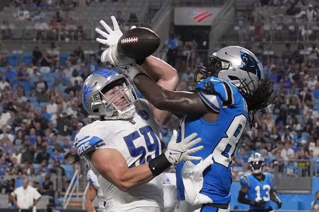 Aug 25, 2023; Charlotte, North Carolina, USA;  Detroit Lions linebacker Trevor Nowaske (59) breaks up a pass in the end zone intended for Carolina Panthers tight end Ian Thomas (80) in the second quarter at Bank of America Stadium.