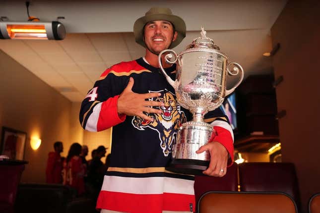 May 22, 2023; Sunrise, Florida, USA; Pro golfer Brooks Koepka poses with the Wanamaker Trophy while attending Game 3 of the Eastern Conference Finals of the 2023 Stanley Cup Playoffs between the Florida Panthers and the Carolina Hurricanes at FLA Live Arena.