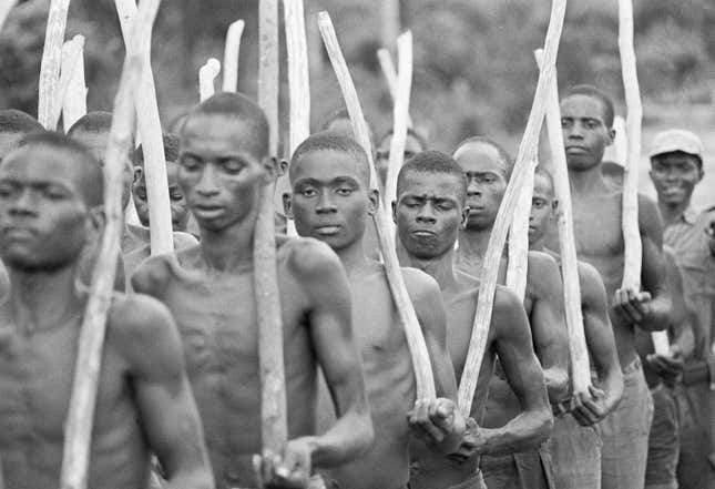 Volunteers for the Biafran army carry rifle-sized sticks as they undergo basic training at Owerri, 1968.