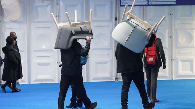 Workers carry chairs supplied by Swedish furniture maker IKEA. IKEA provided seating and tables for delegates at COP26 in 2021 in Glasgow, Scotland.