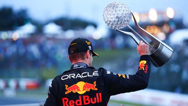 A photo of Max Verstappen with the winners trophy in Japan. 