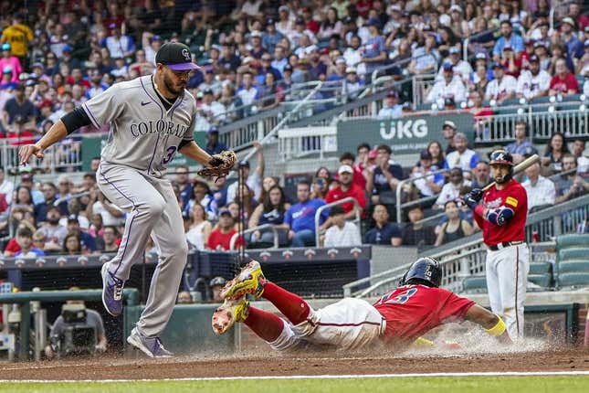 Jun 16, 2023; Cumberland, Georgia, USA; Atlanta Braves right fielder Ronald Acuna Jr. (13) scores under Colorado Rockies starting pitcher Dinelson Lamet (32) after a wild pitch during the first inning at Truist Park.