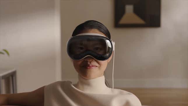 An image shows a woman wearing Apple's headset.