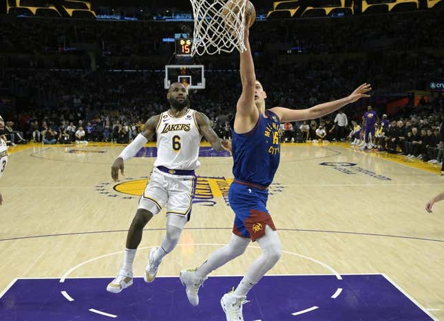 May 20, 2023; Los Angeles, California, USA; Denver Nuggets center Nikola Jokic (15) shoots against Los Angeles Lakers forward LeBron James (6) in the first half during game three of the Western Conference Finals for the 2023 NBA playoffs at Crypto.com Arena.