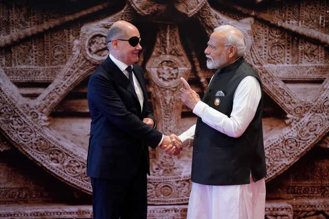 Indian Prime Minister Narendra Modi talks to Germany Chancellor Olaf Scholz upon his arrival at Bharat Mandapam convention center for the G20 Summit, in New Delhi, India, Saturday, Sept. 9, 2023. (AP Photo/Evan Vucci,Pool)