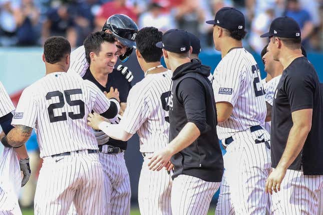 Sep 10, 2023; Bronx, New York, USA;  New York Yankees catcher Kyle Higashioka (66) celebrates with his teammates after hitting a game winning RBI double in the thirteenth inning against the Milwaukee Brewers at Yankee Stadium.