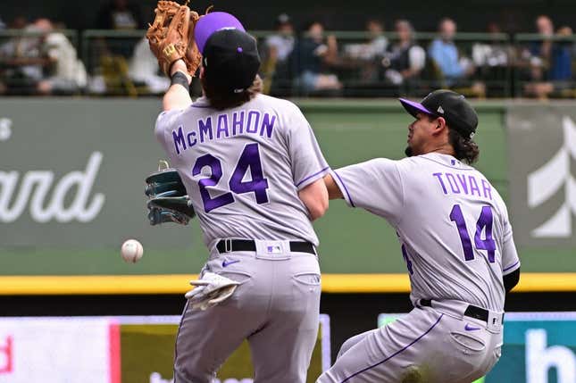 Aug 9, 2023; Milwaukee, Wisconsin, USA; Colorado Rockies shortstop Ezequiel Tovar (14) and third baseman Ryan McMahon (24) cannot catch a foul ball hit by Milwaukee Brewers right fielder Sal Frelick (not pictured) in the fifth inning at American Family Field.