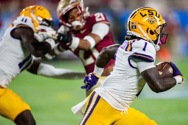 LSU&#39;s Aaron Anderson runs with the ball against the Florida State Seminoles 17-14 at the half of the Camping World Kickoff on Sunday, Sept. 3, 2023.