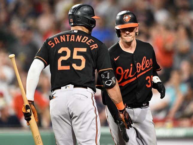 Sep 8, 2023; Boston, Massachusetts, USA; Baltimore Orioles catcher Adley Rutschman (35) high-fives right fielder Anthony Santander (25) after hitting a home run against the Boston Red Sox during the eighth inning at Fenway Park.
