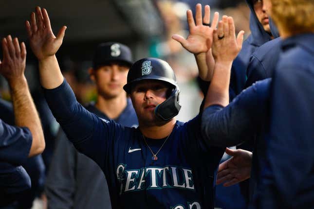 May 22, 2023; Seattle, Washington, USA; Seattle Mariners first baseman Ty France (23) celebrates in the dugout after scoring a run off a single hit by third baseman Eugenio Suarez (28) during the sixth inning against the Oakland Athletics at T-Mobile Park.