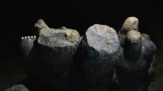 Charcoal sits in a carved-out stalagmite.