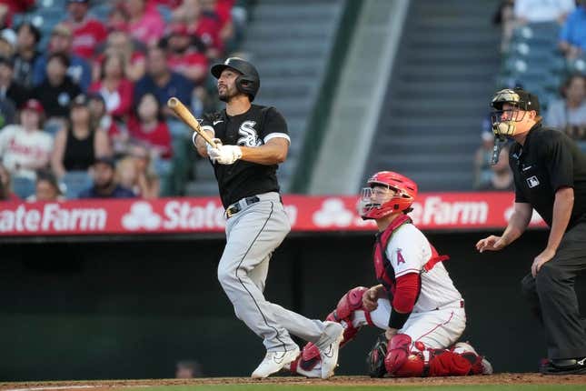 Jun 28, 2023; Anaheim, California, USA; Chicago White Sox catcher Seby Zavala (44) follows through on a home run in the second inning as Los Angeles Angels catcher Chad Wallach (35) and home plate umpire Chad Whiston watch at Angel Stadium.
