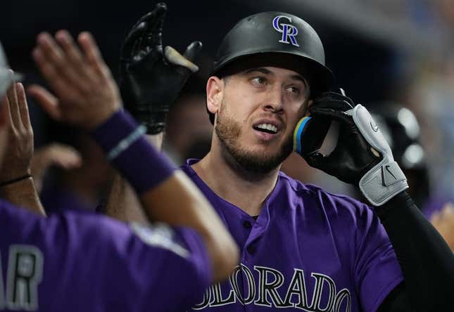 Jul 21, 2023; Miami, Florida, USA;  Colorado Rockies first baseman C.J. Cron (25) is congratulated after hitting a two-run home run in the first inning against the Miami Marlins at loanDepot Park.