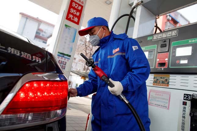 An attendant filling a car at a Sinopec gas station