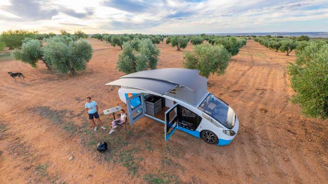 The solar-powered campervan is set up to charge with its roof extended to show its solar tiles
