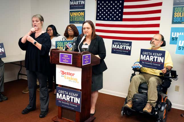 Greta Kemp Martin, the Democratic nominee for Mississippi attorney general, at podium, discusses her proposal to create a fair labor division as part of the attorney general's office during a Thursday, Aug. 31, 2023, news conference in Jackson, Miss. (AP Photo/Rogelio V. Solis)