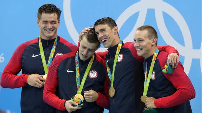 Team USA’s Nathan Adrian, Ryan Held, Michael Phelps, and Caeleb Dressel celebrate their win.