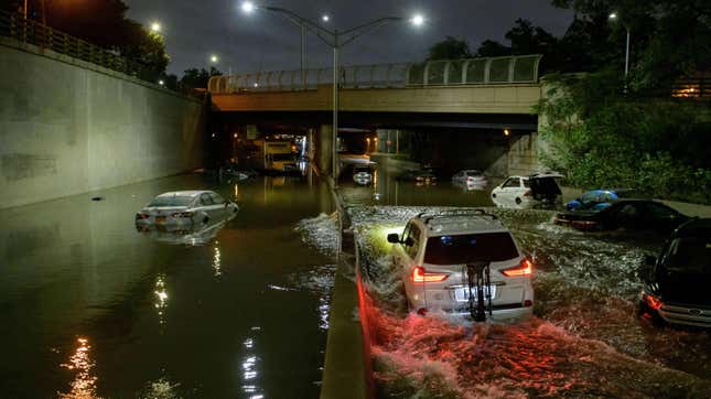 Floodwater surrounds vehicles following heavy rain on an expressway in Brooklyn, New York early on September 2, 2021, as flash flooding and record-breaking rainfall brought by the remnants of Storm Ida swept through the area. 