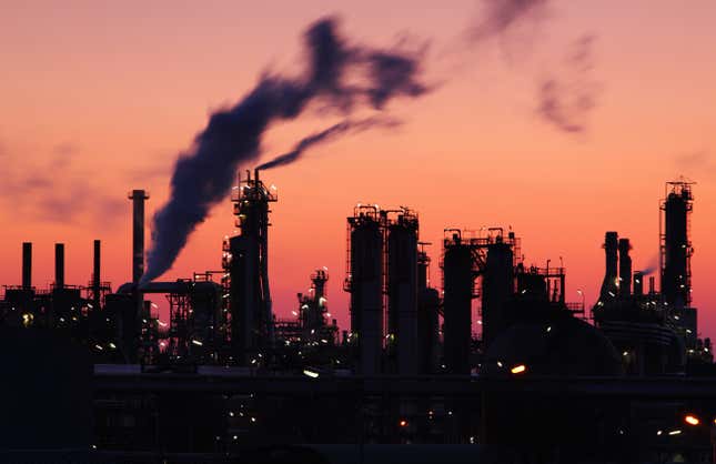 Stock photo of oil refinery at sunset