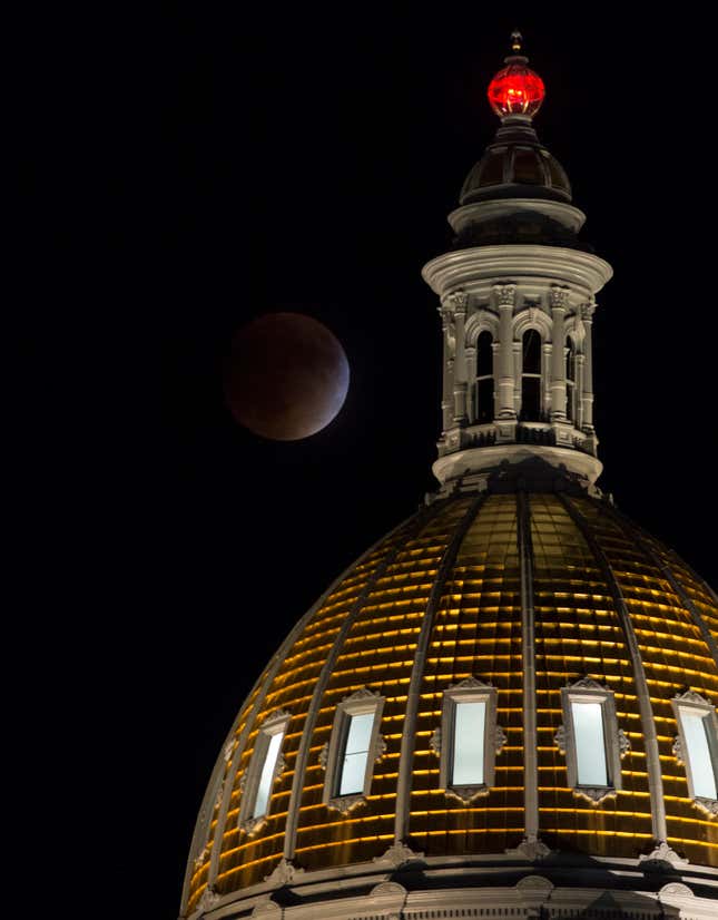 A perigee full moon, or supermoon, is seen during a total lunar eclipse behind the Colorado State Capitol Building on Sunday, Sept. 27, 2015, in Denver.