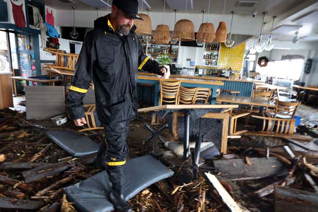 Kitchen manager Josh Whitby inspects the wreckage of Zelda’s on the Beach in Capitola Village after the restaurant sustained major damage from the storm on Thursday, Jan. 5, 2023, in Capitola, California.
