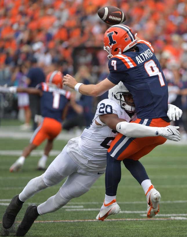 Sep 16, 2023; Champaign, Illinois, USA;  Penn State Nittany Lions defensive end Adisa Isaac (20) tackles Illinois Fighting Illini quarterback Luke Altmyer (9) as he passes the ball during the second half at Memorial Stadium.