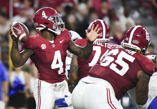 Sep 2, 2023; Tuscaloosa, Alabama, USA;  Alabama Crimson Tide quarterback Jalen Milroe (4) throws behind a block by offensive lineman JC Latham (65) against the Middle Tennessee Blue Raiders during the first half at Bryant-Denny Stadium.