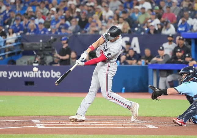Jun 11, 2023; Toronto, Ontario, CAN; Minnesota Twins left fielder Trevor Larnach (9) hits a two-run single against the Toronto Blue Jays during the first inning at Rogers Centre.