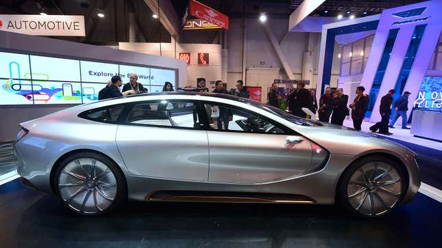 A photo of a silver LeSee concept car at an auto show. 
