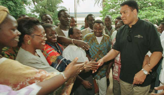 Muhammad Ali shakes hands with fans in Abidjan, Ivory Coast in 1997.