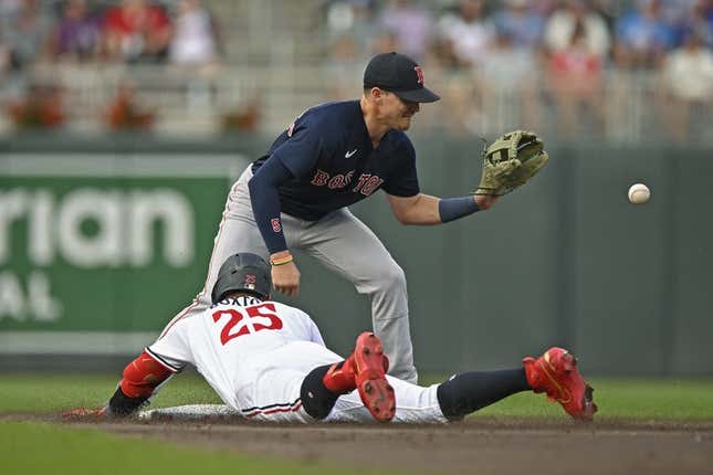 Jun 21, 2023; Minneapolis, Minnesota, USA;  Minnesota Twins designated hitter Byron Buxton (25) beats the tag of Boston Red Sox infielder Enrique Hernandez (5) for a double during the second inning at Target Field.