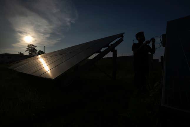 An employee checks solar panels fixed near a hydrogen plant at Oil India Limited in Jorhat, India, Thursday, Aug. 17, 2023. Green hydrogen is being touted around the world as a clean energy solution to take the carbon out of high-emitting sectors like transport and industrial manufacturing. But it’s not green hydrogen unless the energy used to produce it is renewable, like solar or wind energy. (AP Photo/Anupam Nath)