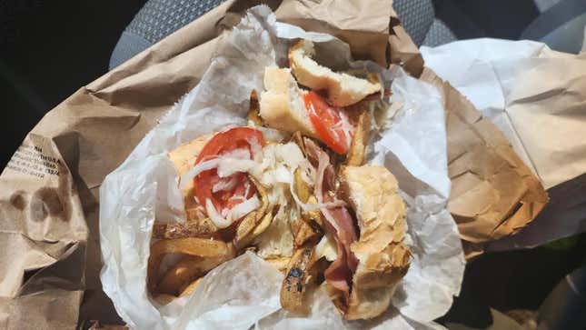 Primanti Bros. Sandwich open on wax paper atop brown paper bag
