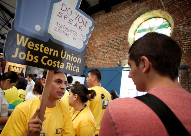 A Western Union requiter speaks with a job seeker. Companies are increasingly targeting bilingual employees.