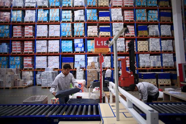 Employees work at a Tmall logistic center in Suzhou, Jiangsu province.