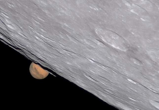 Mars peeking out from behind the Moon.