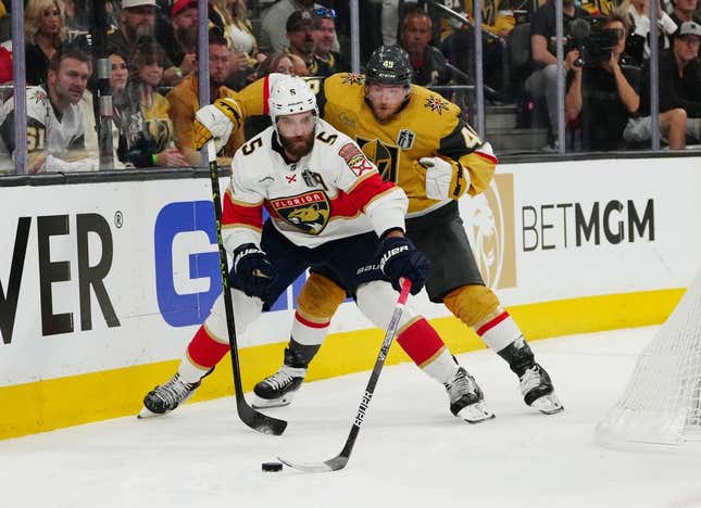 Jun 3, 2023; Las Vegas, Nevada, USA; Florida Panthers defenseman Aaron Ekblad (5) controls the puck against Vegas Golden Knights center Ivan Barbashev (49) during the second period in game one of the 2023 Stanley Cup Final at T-Mobile Arena.