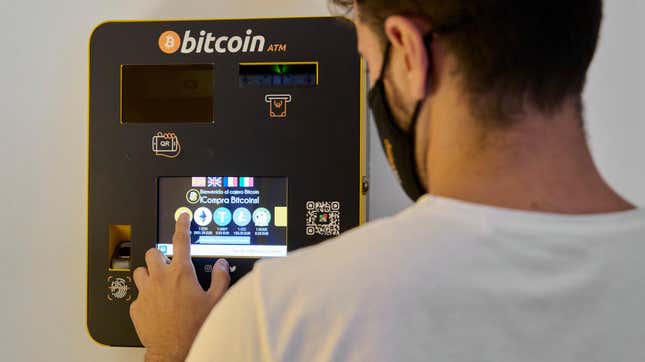 A m,an using a General Bytes cryptocurrency ATM in Palma de Mallorca, Spain in August 2021.