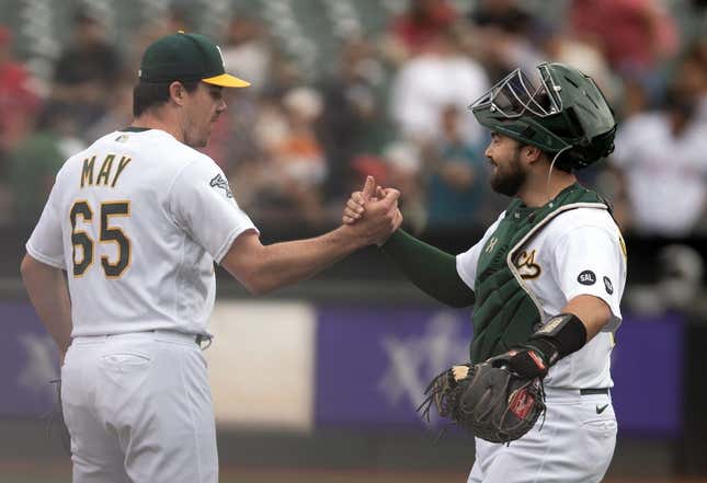 Sep 2, 2023; Oakland, California, USA; Oakland Athletics pitcher Trevor May (65) and catcher Shea Langeliers (23) celebrate their 2-1 victory over the Los Angeles Angels at Oakland-Alameda County Coliseum.