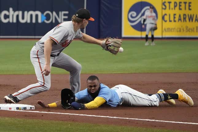 Jun 21, 2023; St. Petersburg, Florida, USA; Tampa Bay Rays center fielder Manuel Margot (13) dives safely into third as Baltimore Orioles third baseman Gunnar Henderson (2) tries to make the tag off a sacrifice fly hit by catcher Christian Bethancourt (not pictured) during the second inning at Tropicana Field.