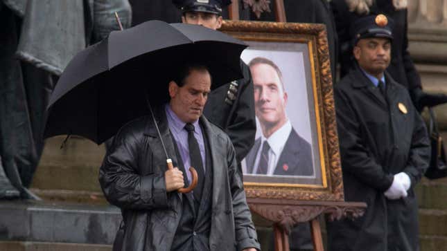 Colin Farrell holds an umbrella in costume as The Penguin on the set of The Batman.
