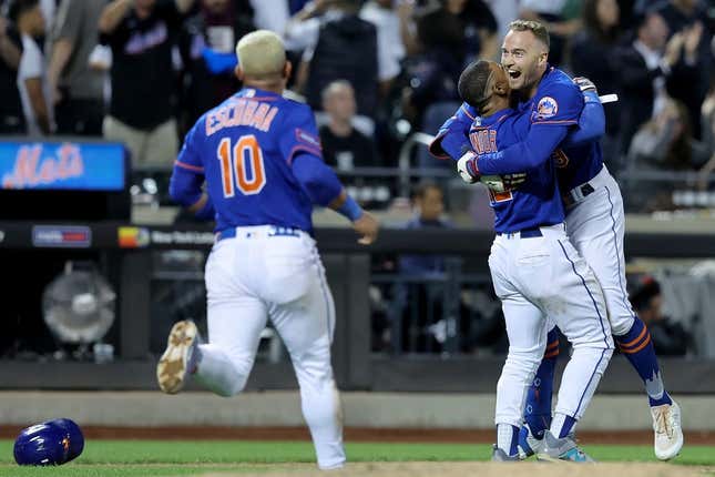 Jun 14, 2023; New York City, New York, USA; New York Mets center fielder Brandon Nimmo (9) celebrates with shortstop Francisco Lindor (12) and third baseman Eduardo Escobar (10) after hitting a tenth inning walkoff double against the New York Yankees at Citi Field.