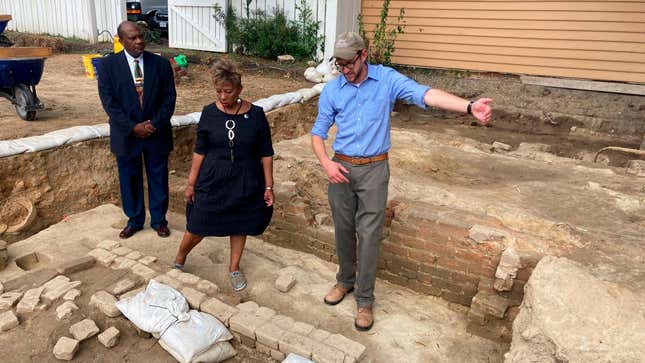 Reginald F. Davis, from left, pastor of First Baptist Church in Williamsburg, Connie Matthews Harshaw, a member of First Baptist, and Jack Gary, Colonial Williamsburg’s director of archaeology, stand at the brick-and-mortar foundation of one the oldest Black churches in the U.S. on Wednesday, Oct. 6, 2021, in Williamsburg, Va. Colonial Williamsburg announced Thursday Oct. 7, that the foundation had been unearthed by archeologists.