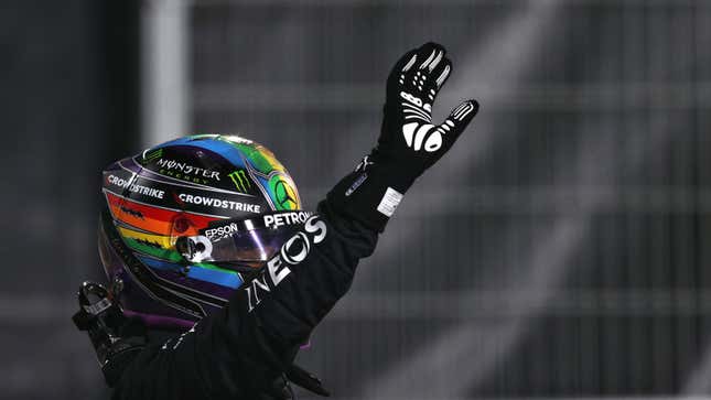 Lewis Hamilton wearing a helmet with the Pride colors displayed 