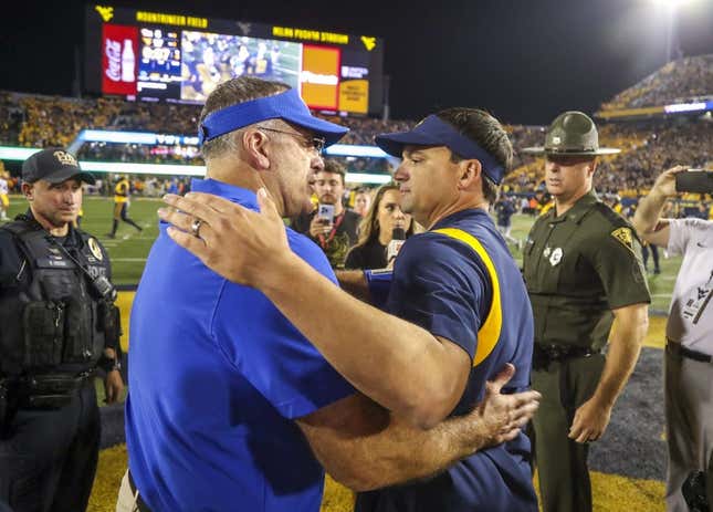 Sep 16, 2023; Morgantown, West Virginia, USA; West Virginia Mountaineers head coach Neal Brown speaks with Pittsburgh Panthers head coach Pat Narduzzi after the game at Mountaineer Field at Milan Puskar Stadium.